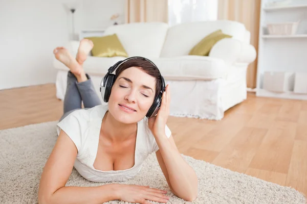 Uśmiechnięta brunetka słuchanie muzyki — Zdjęcie stockowe