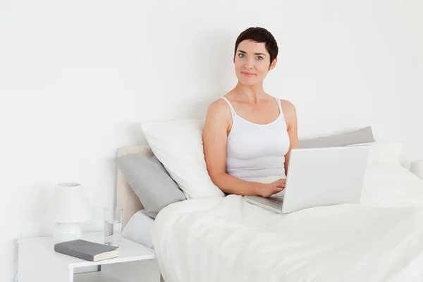 Charming woman using a laptop — Stock Photo, Image