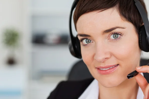 Close up of a cute secretary calling with a headset — Stock Photo, Image