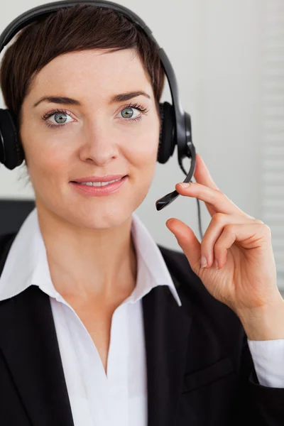 Portrait of a smiling secretary with a headset — Stock Photo, Image