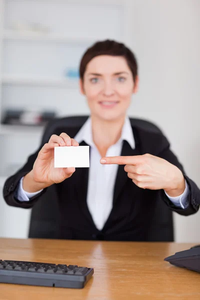 Portrait of a secrertary pointing at a blank business card — Stock Photo, Image