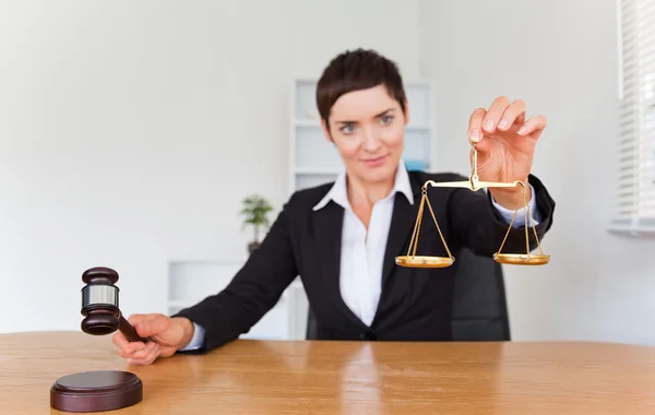 Professional woman with a gavel and the justice scale — Stock Photo, Image