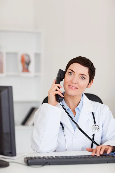 電話をかける笑みを浮かべて女性医師の肖像画 — ストック写真