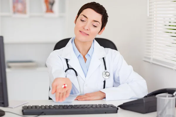 Ženský doktor ukazuje pilulky — Stock fotografie