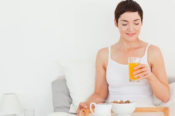 Woman drinking orange juice — Stock Photo, Image
