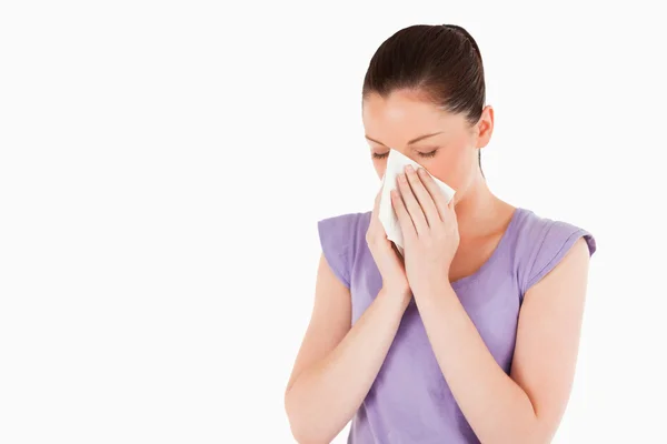 Good looking woman sneezing while standing — Stock Photo, Image