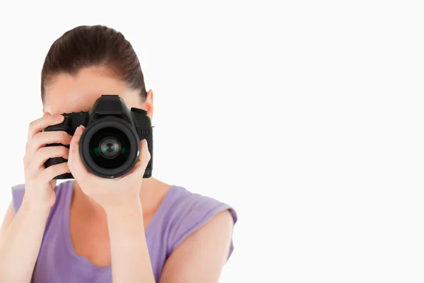 Beautiful female using a camera while standing — Stock Photo, Image