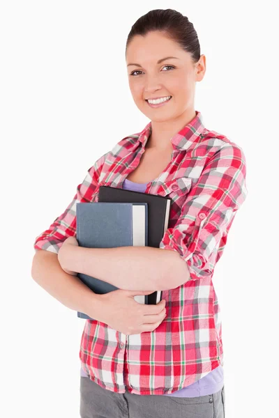 Beautiful female posing with books while standing — Stock Photo, Image