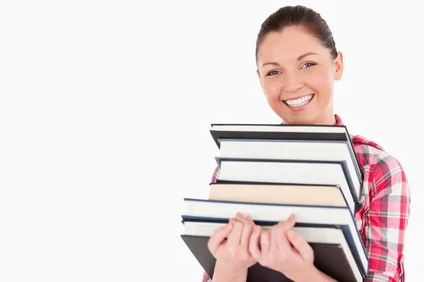 Gorgeous female posing with books while standing — Stock Photo, Image