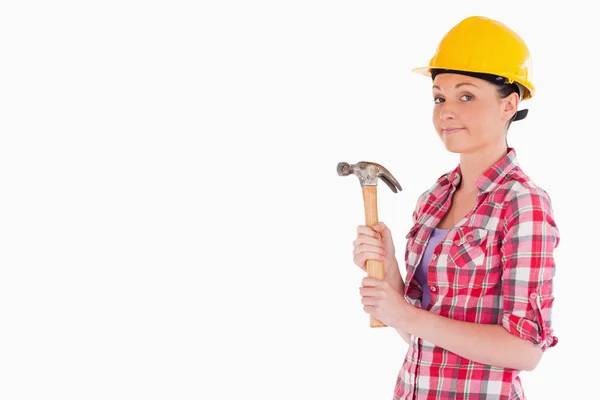 Beautiful woman holding a hammer while standing — Stock Photo, Image