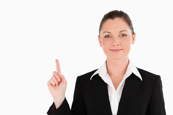 Good looking woman in suit pointing at a copy space — Stock Photo, Image