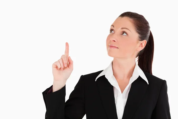 Pretty woman in suit pointing at a copy space — Stock Photo, Image