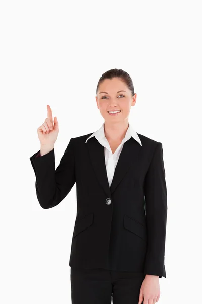Cute woman in suit pointing at a copy space — Stock Photo, Image