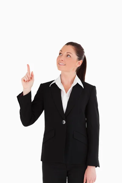 Vacker kvinna i kostym som pekar på en kopia utrymme — Stockfoto