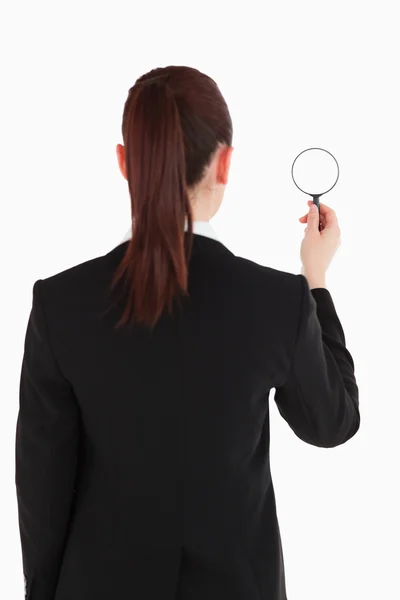 Beautiful woman in suit being back to the camera and holding a m — Stock Photo, Image