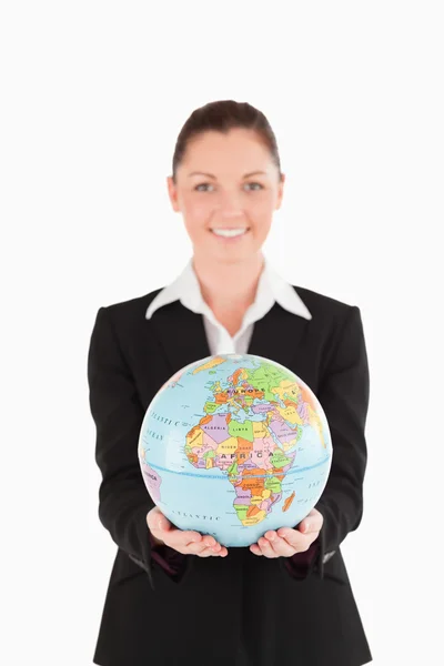 Pretty woman in suit holding a globe — Stock Photo, Image