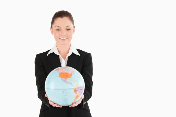 Cute woman in suit holding a globe — Stock Photo, Image
