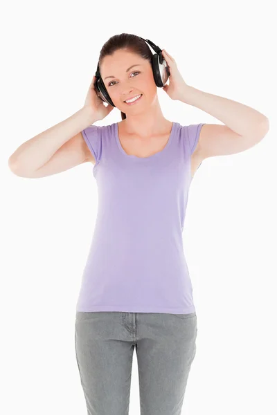 Gut aussehende Frau posiert im Stehen mit Kopfhörern — Stockfoto