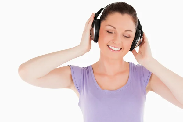Lovely woman posing with headphones while standing — Stock Photo, Image