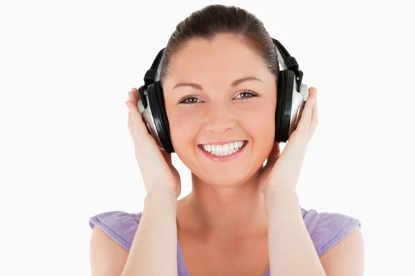 Portrait of a good looking woman posing with headphones while st — Stock Photo, Image