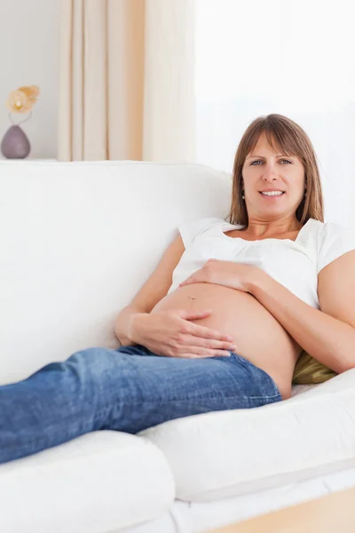 Portrait of a pregnant woman holding her belly Stock Image