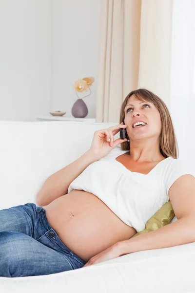 Portrait of a happy pregnant woman phoning Stock Image