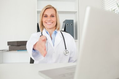 Blonde doctor giving hand clipart