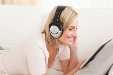 Close up of a woman watching a movie with a tablet computer clipart