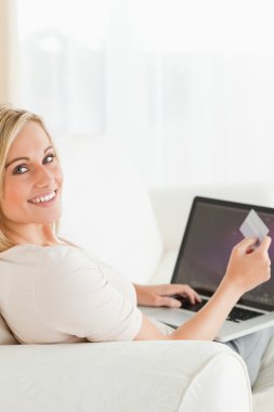 Portrait of a woman paying her bills online clipart