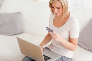 Close up of a woman shopping online clipart