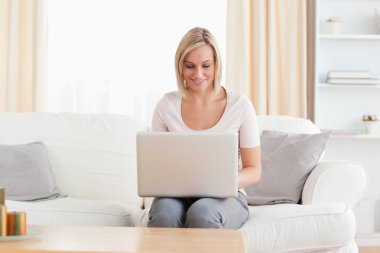 Woman using a laptop clipart