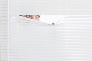 Businesswoman peeking out of a window clipart