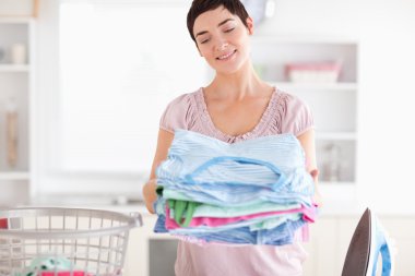 Gorgeous Woman with a pile of clothes clipart