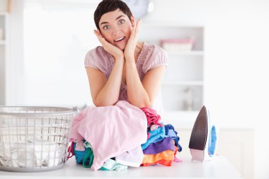 Surprised Woman with a pile of clothes clipart