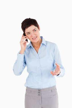 Portrait of a angry woman on the phone clipart