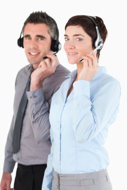 Portrait of operators speaking through headsets clipart