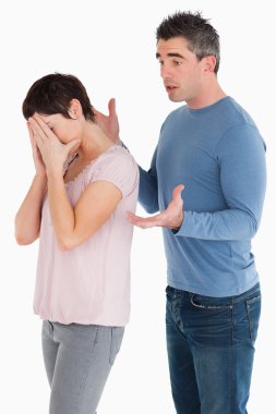 Wife crying while her husband is trying to explain himself clipart