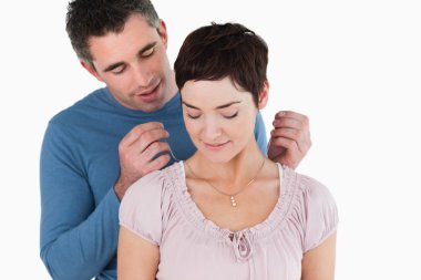 Man offering a necklace to his smiling wife clipart