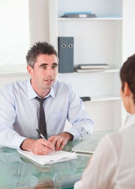 Portrait of a manager interviewing an applicant clipart