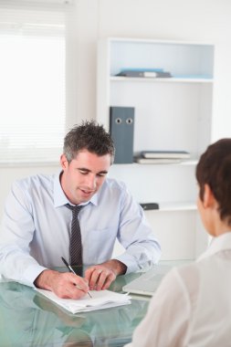 Portrait of a manager interviewing a female applicant clipart