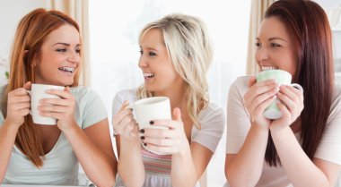 Young Women sitting at a table with cups clipart