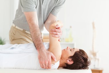 Man stretching a woman's arm clipart