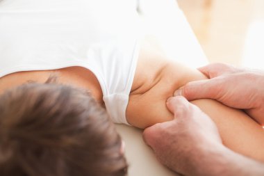 Man massaging a woman's shoulder clipart