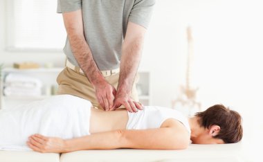 Brunette woman getting a back-massage clipart