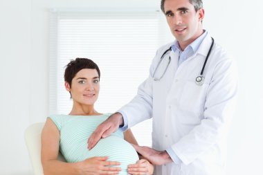 Portrait of a doctor and a pregnant woman clipart