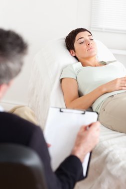 Psychologist talking to a female patient clipart