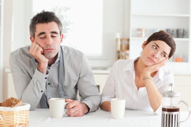 Unhappy couple drinking coffee clipart