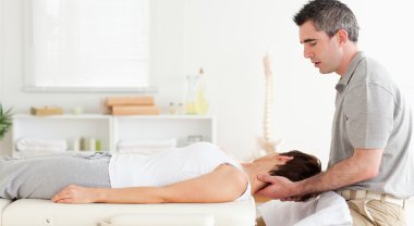 Masseur stretching customer's head clipart