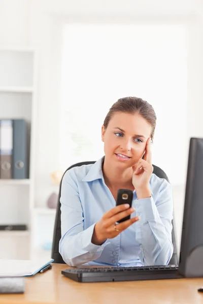 Calm office working holding her cellphone — Stock Photo, Image