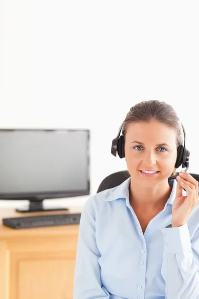 Smiling secretary wearing a headset — Stock Photo, Image